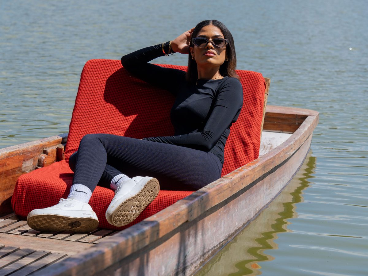 A guest resting in a wooden canoe on a forest lake